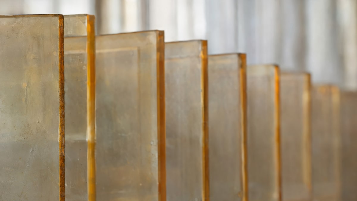 An abstract study: repeating translucent surfaces with muted amber edges and natural scuffs